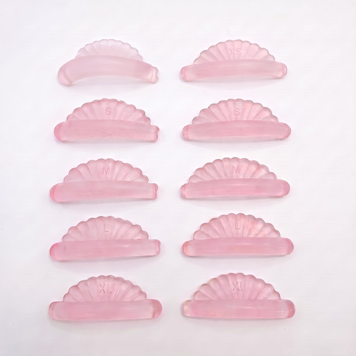 Pink jelly lash lift rods arranged by size in two columns