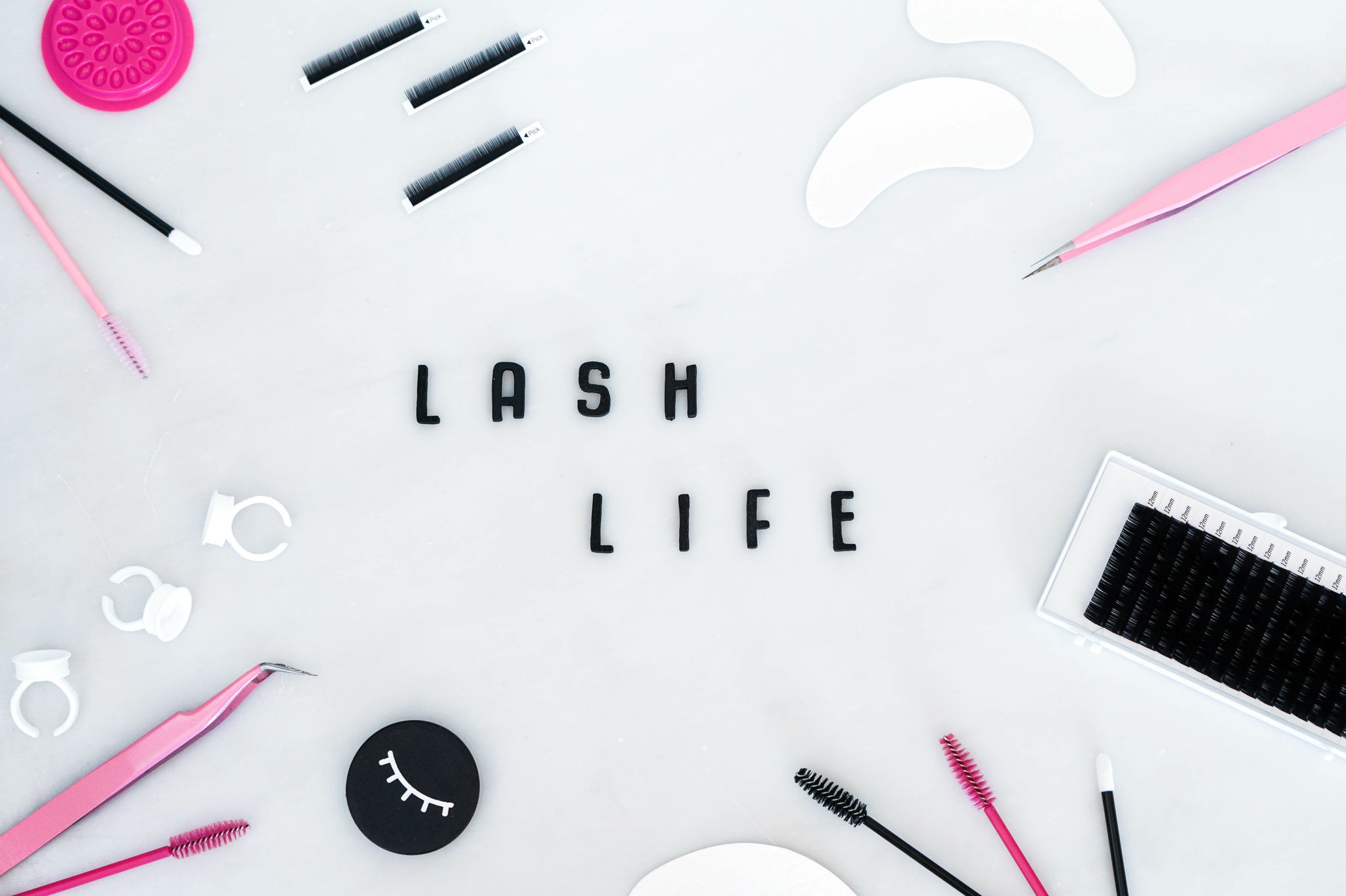 Lash extension supplies with words of lash life in center. Cartel Lash 