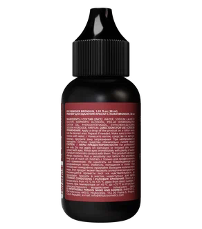 A small black bottle with a pointed black cap, showing a dark red back label with fine white text, isolated on a white background.
