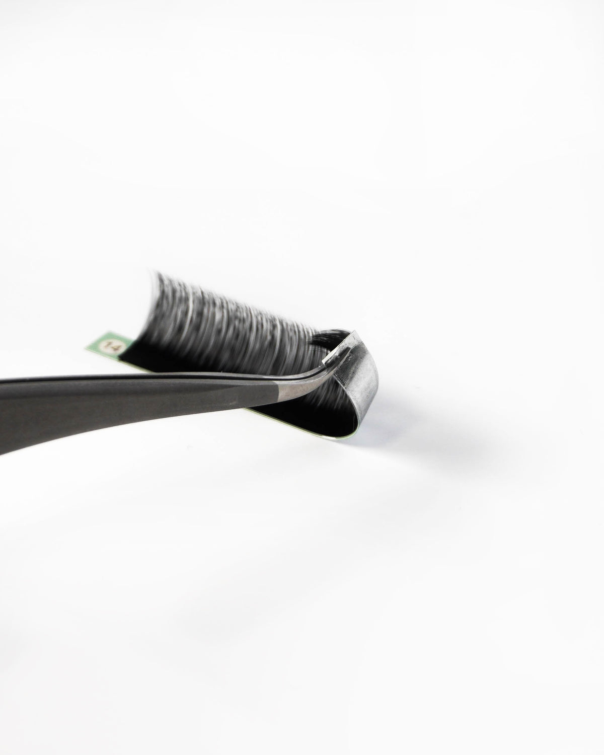 A close-up of lash extension strip, photographed on a clean white background.