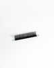 A single strip of black eyelash extensions or a lash strip, photographed on a clean white background.
