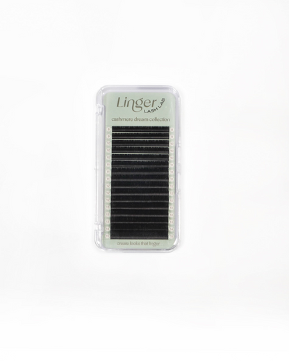 A pack of eyelash extensions in a clear plastic case with a light green label that reads 'Linger lashes' and 'cashmere dream collection'.