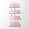 Four pink glitter crown-shaped lash lift shields arranged vertically on a plain white background