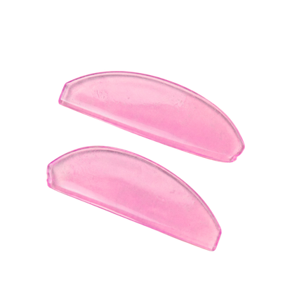 Two translucent pink lash lift shields, shown on a plain white background.