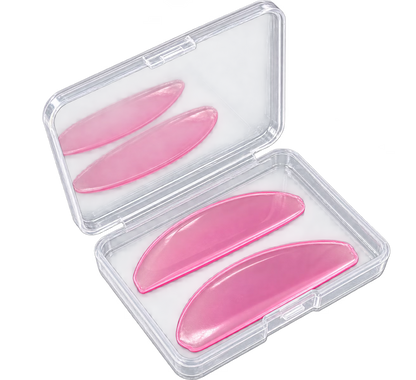 Three flat lash lifting shields displayed inside an open clear plastic case on a white background.