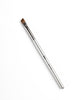 Thuya Brow Dye Brush with silver handle and angled brown bristles