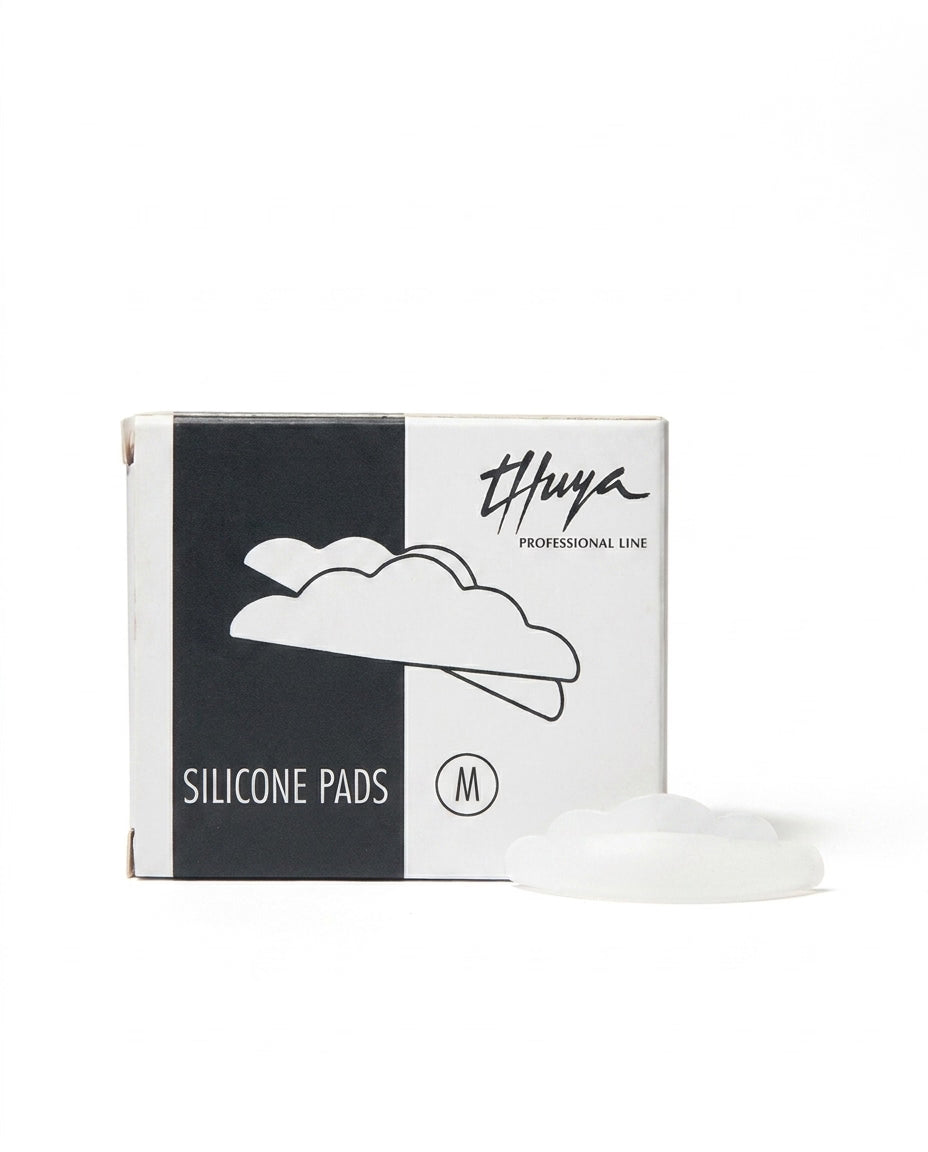 A box of Thuya Professional Line Silicone Pads size M, shown next to a single white silicone pad on a clean white background.