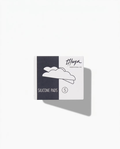 A square product box for Thuya Professional Line Silicone Pads, size S, featuring a split black and white design.